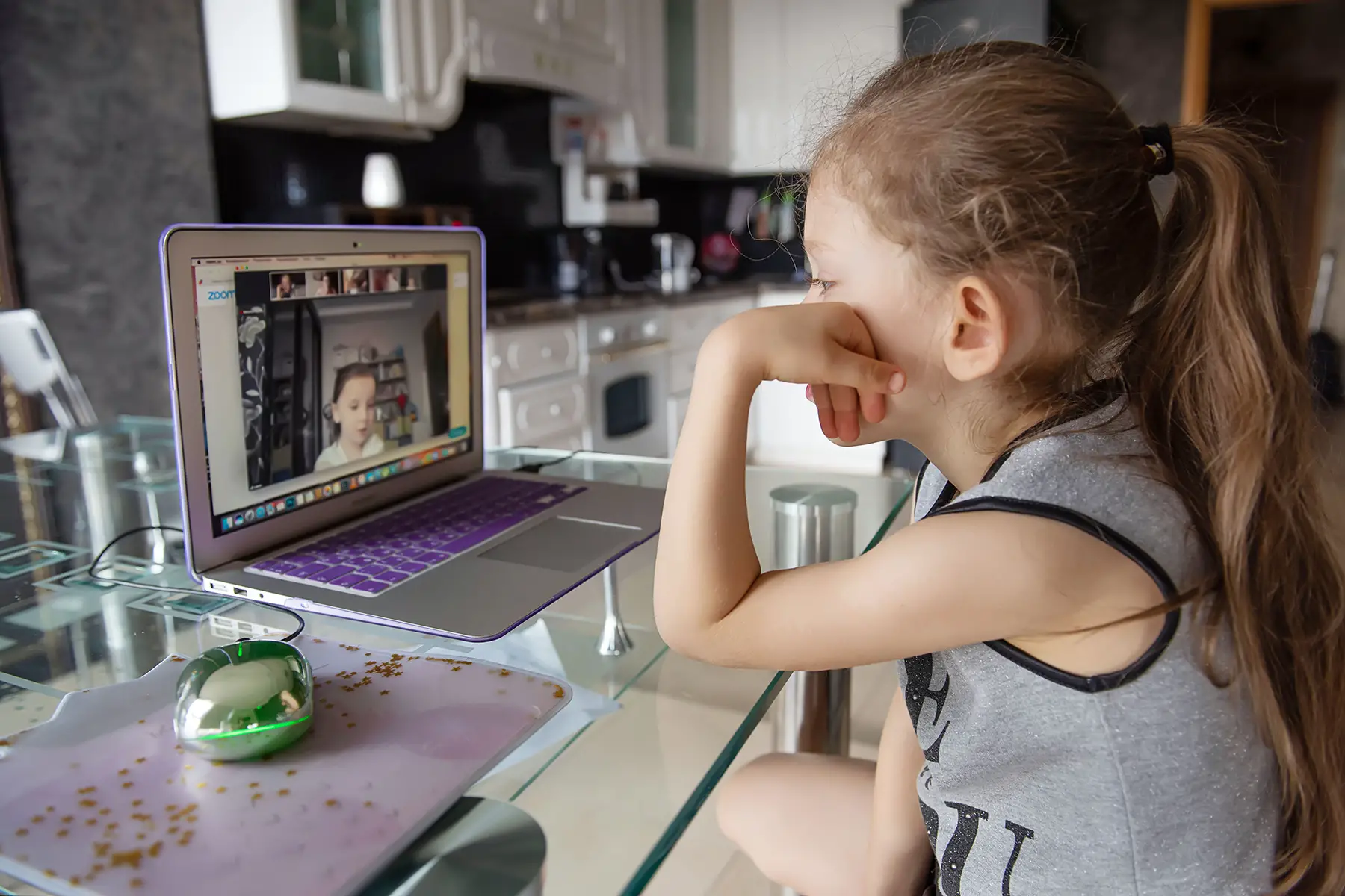 A girl making a video call in a kitchen