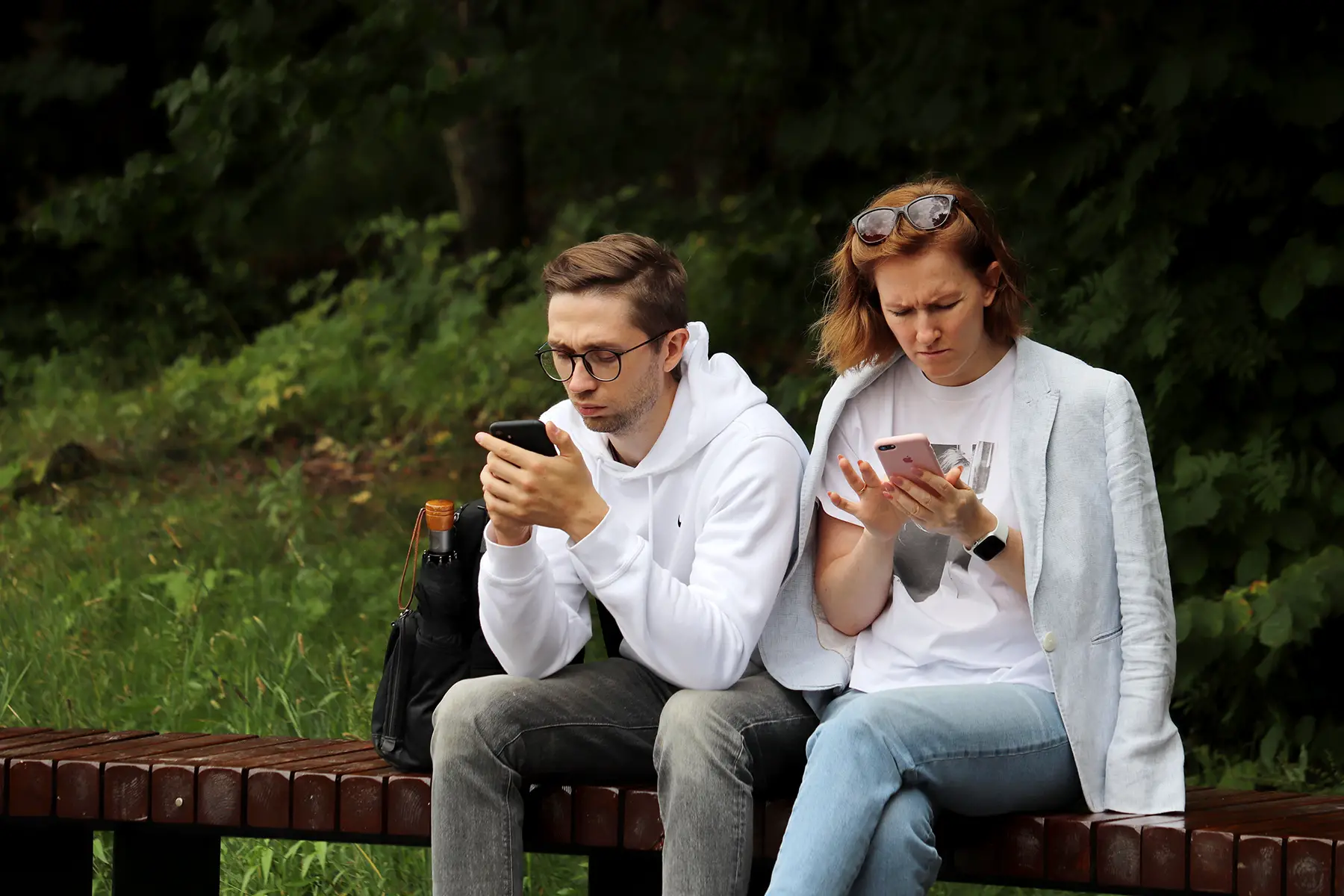 Two people looking at their phones in Russia