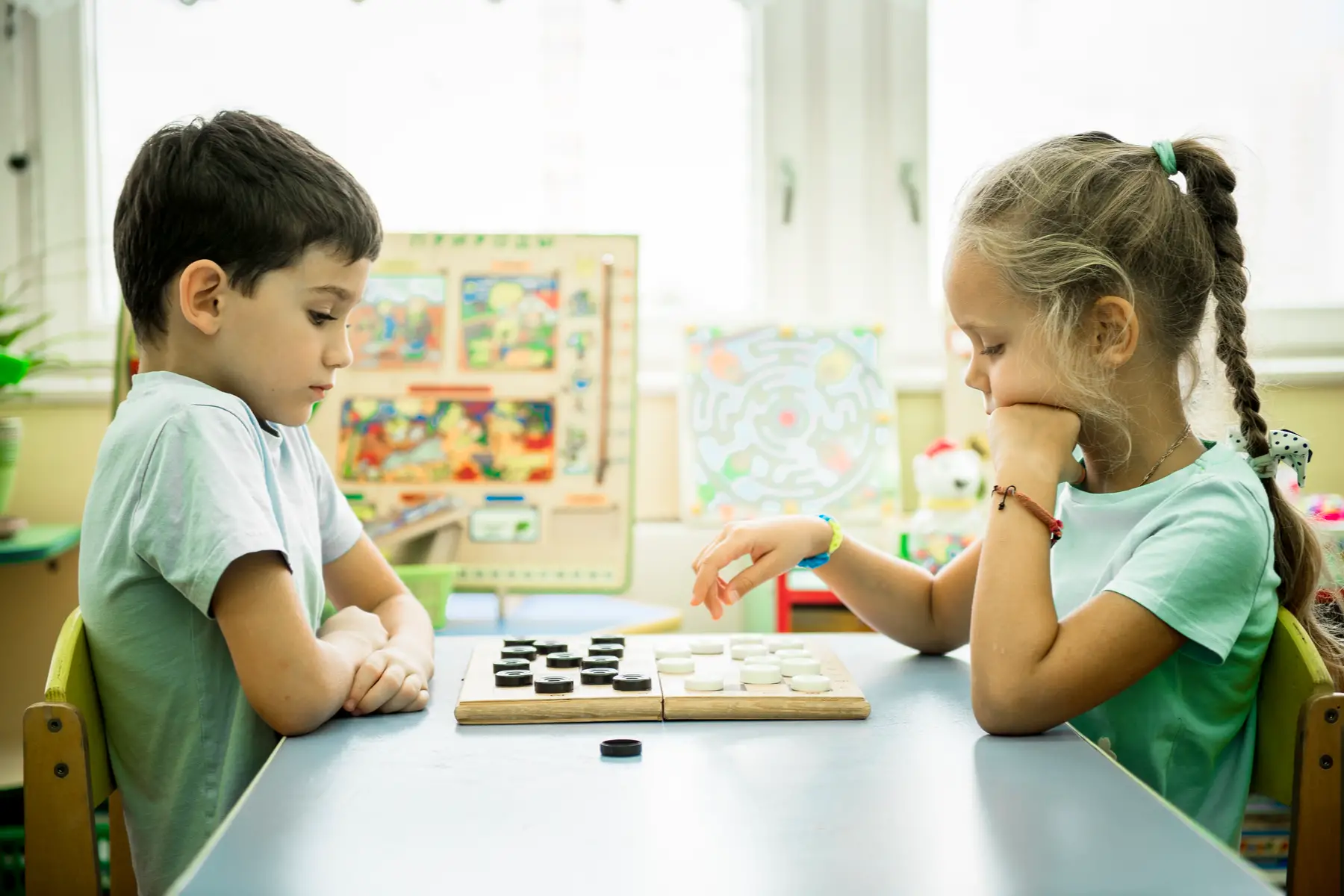 Young children playing checkers