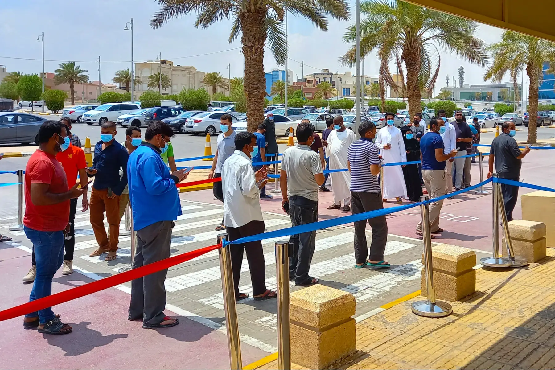 a group of people waiting for the COVID-19 vaccination outside the Expo Center in Riyadh, Saudi Arabia