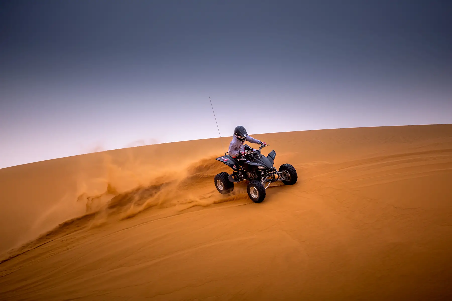 Quad surfing on a dune in Saudi Arabia