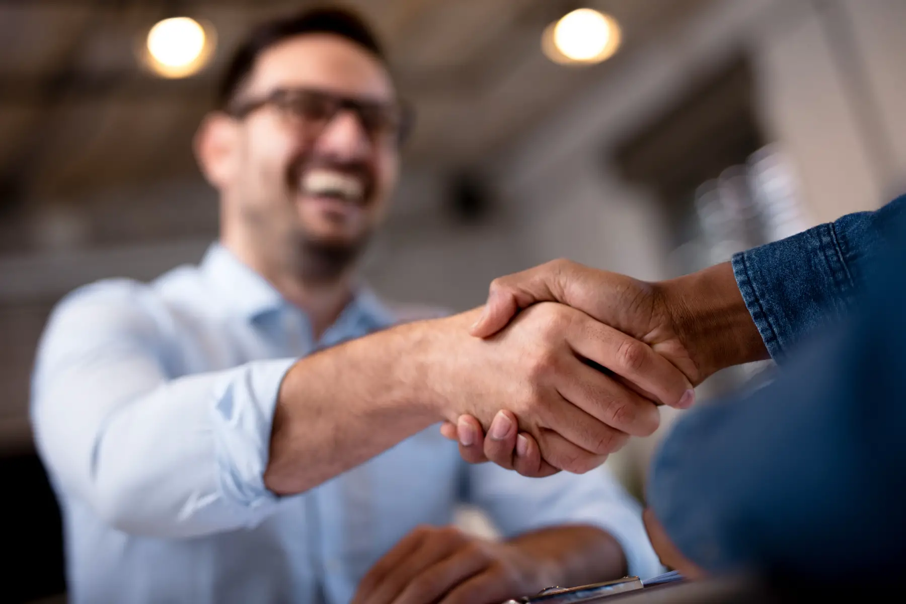 Candidate offering a handshake at a job interview
