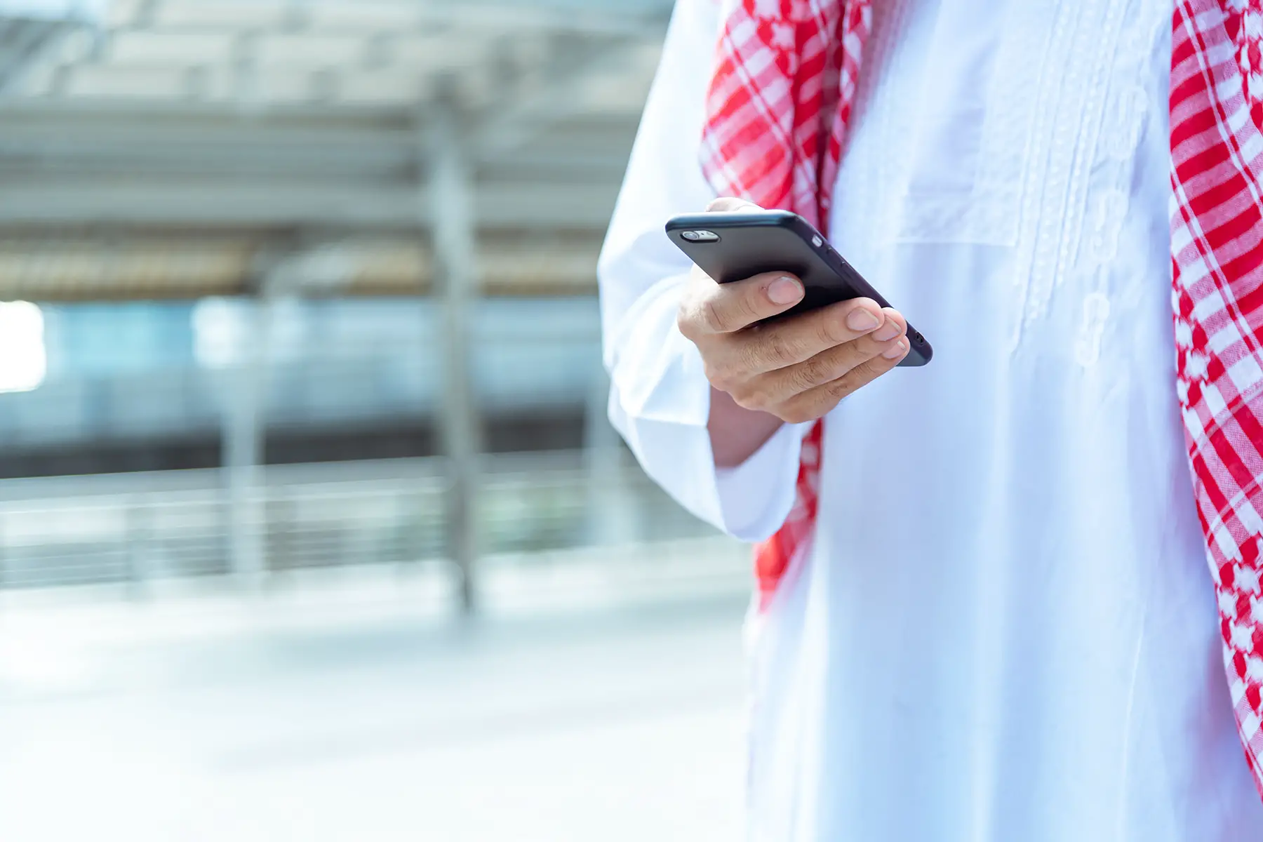 A man using his smartphone in Saudi Arabia
