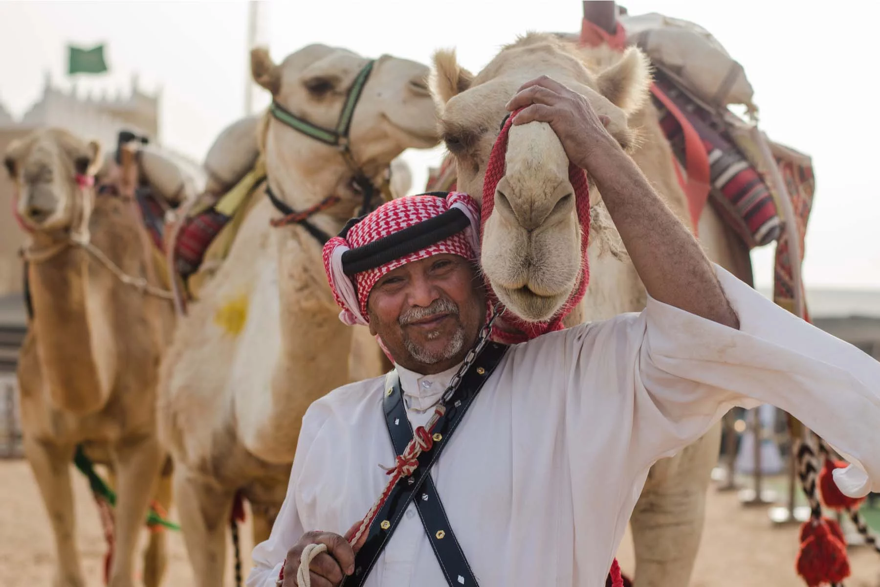 man smiling with camel