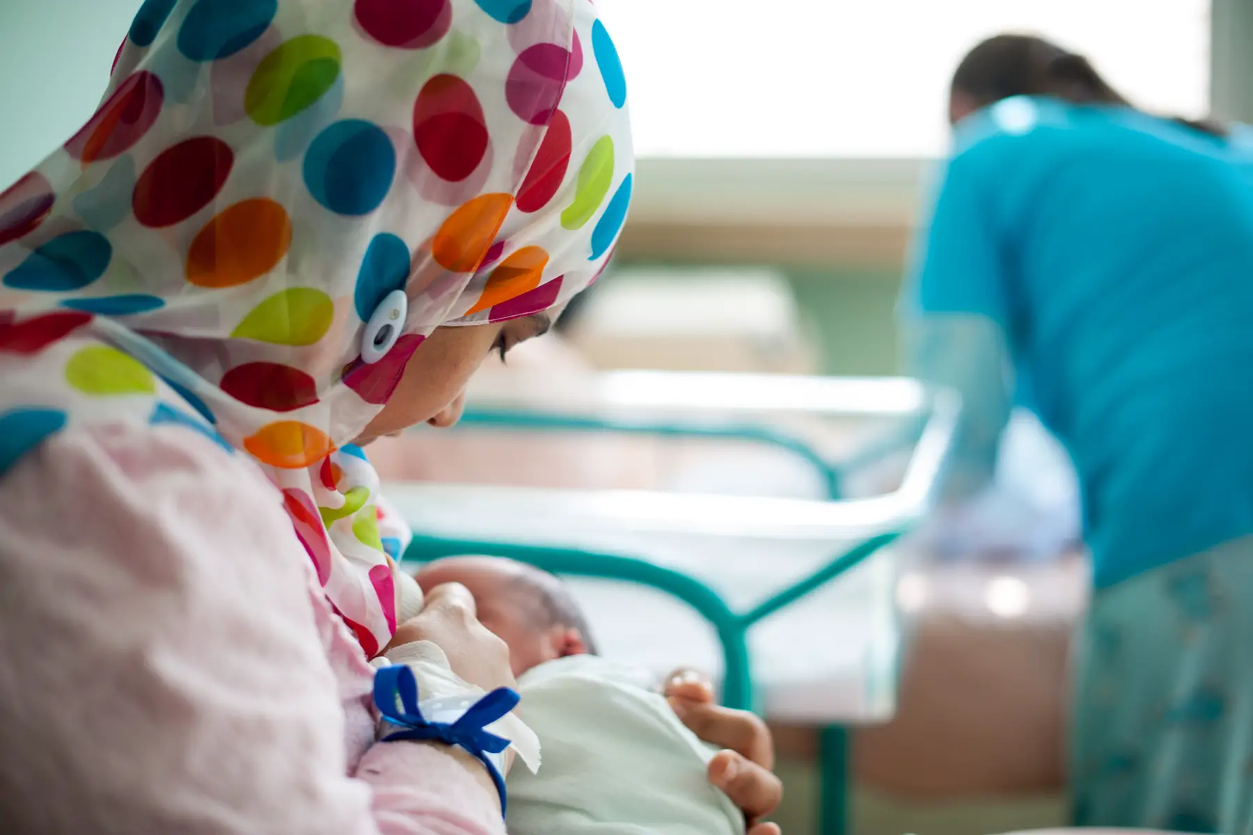muslim mum breastfeeding newborn in hospital