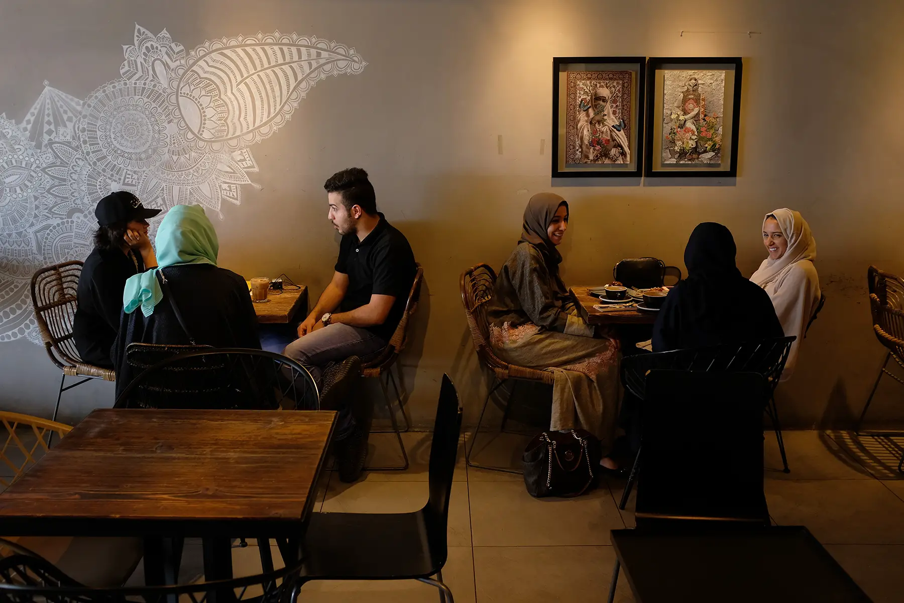 Customers sitting at tables and talking at a café in Jeddah
