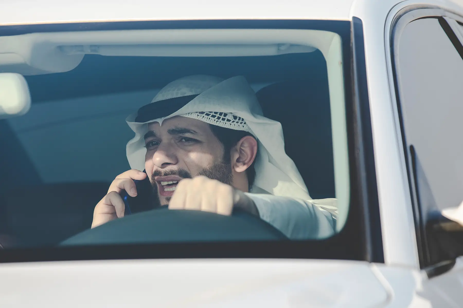 A man in Saudi Arabia calling while driving