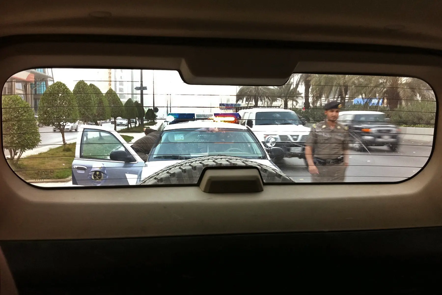 Police in Saudi Arabia approaching a car they pulled over
