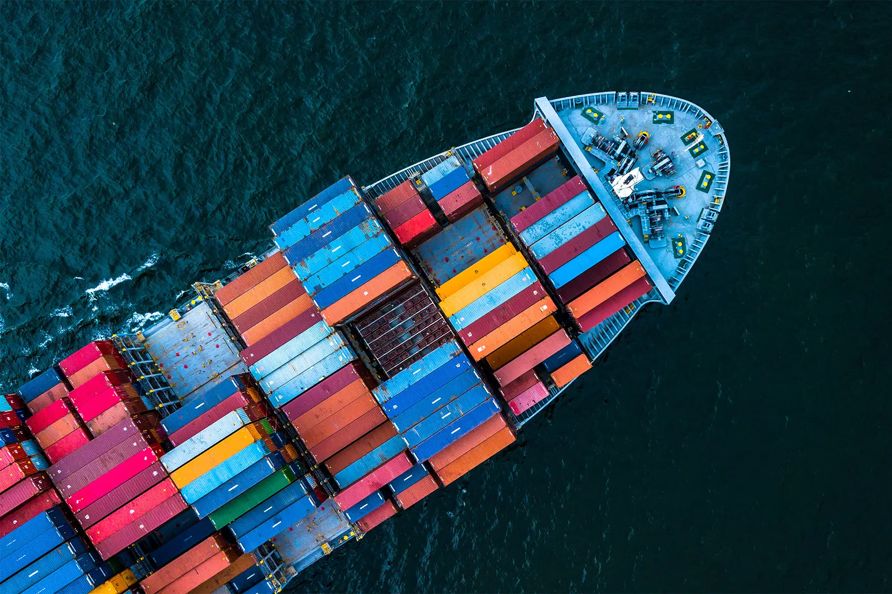 an aerial view of a container cargo ship transporting goods by sea