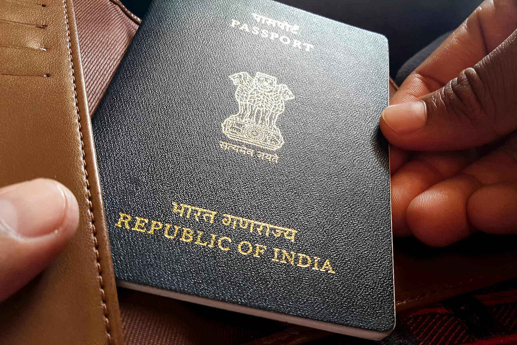 Traveler holding an Indian passport