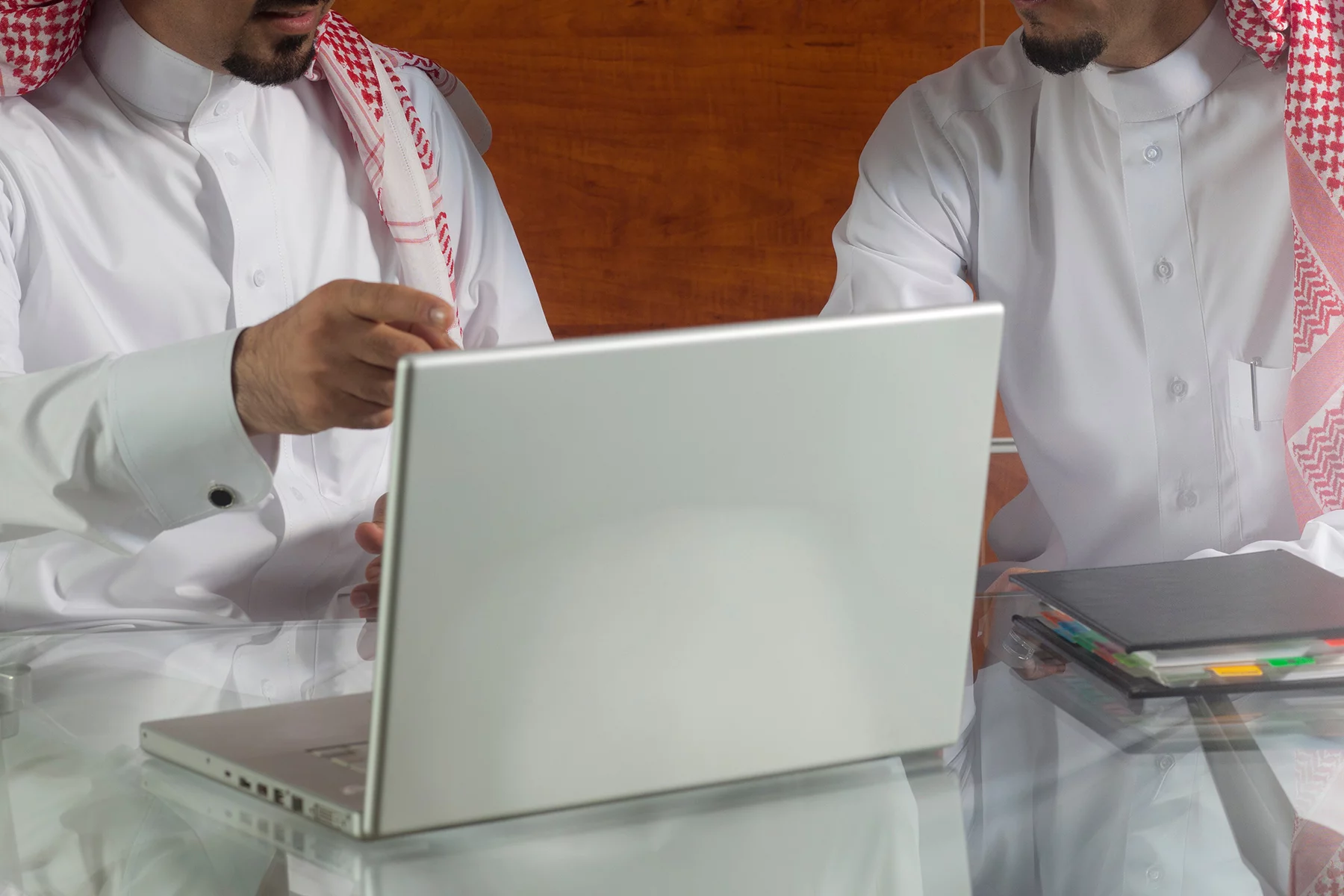 Two Saudi businessmen having a meeting