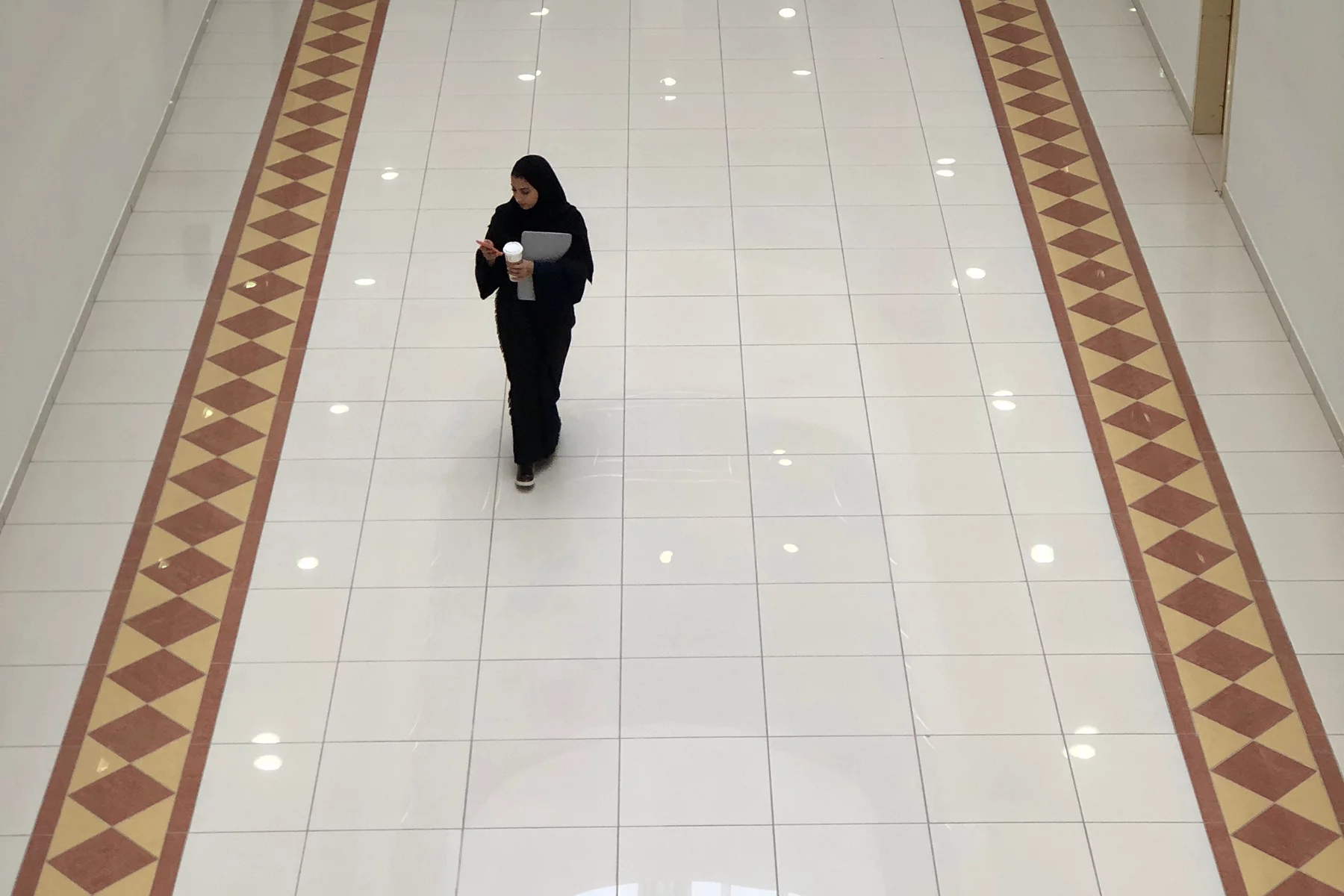 Woman walking through an office in Riyadh, Saudi Arabia