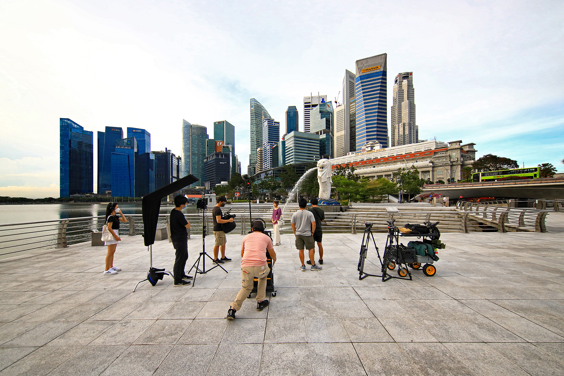 A film crew on location at Merlion Park in Singapore - they do not need work visas