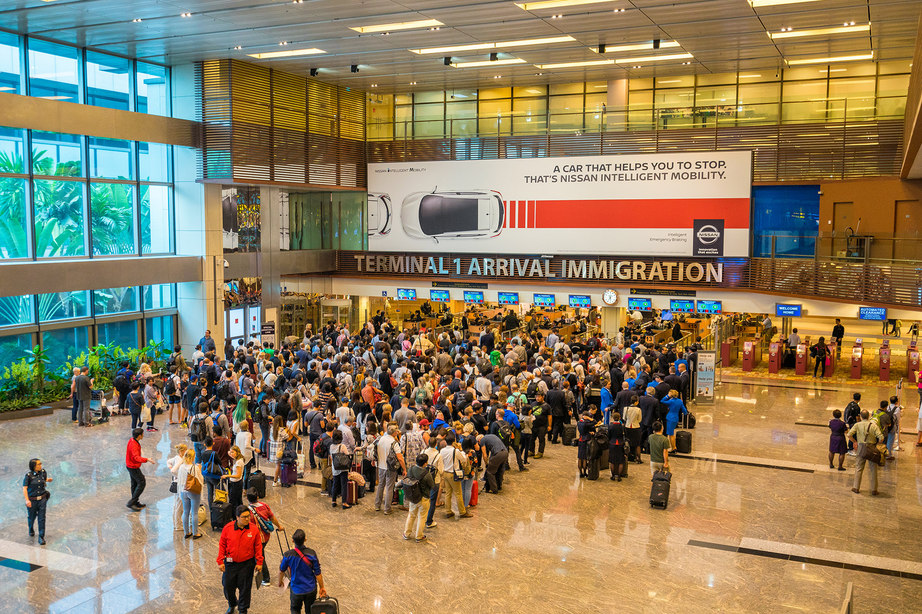 People queue at immigration in Changi Airport, Singapore