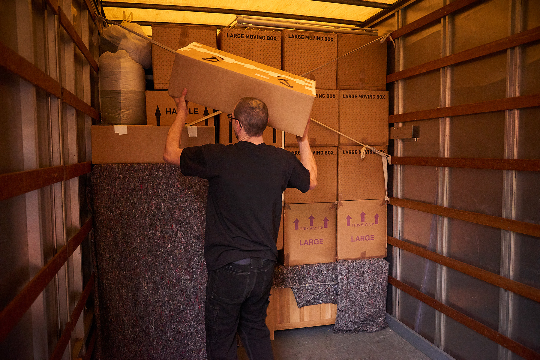 Man loading boxes into a removal van