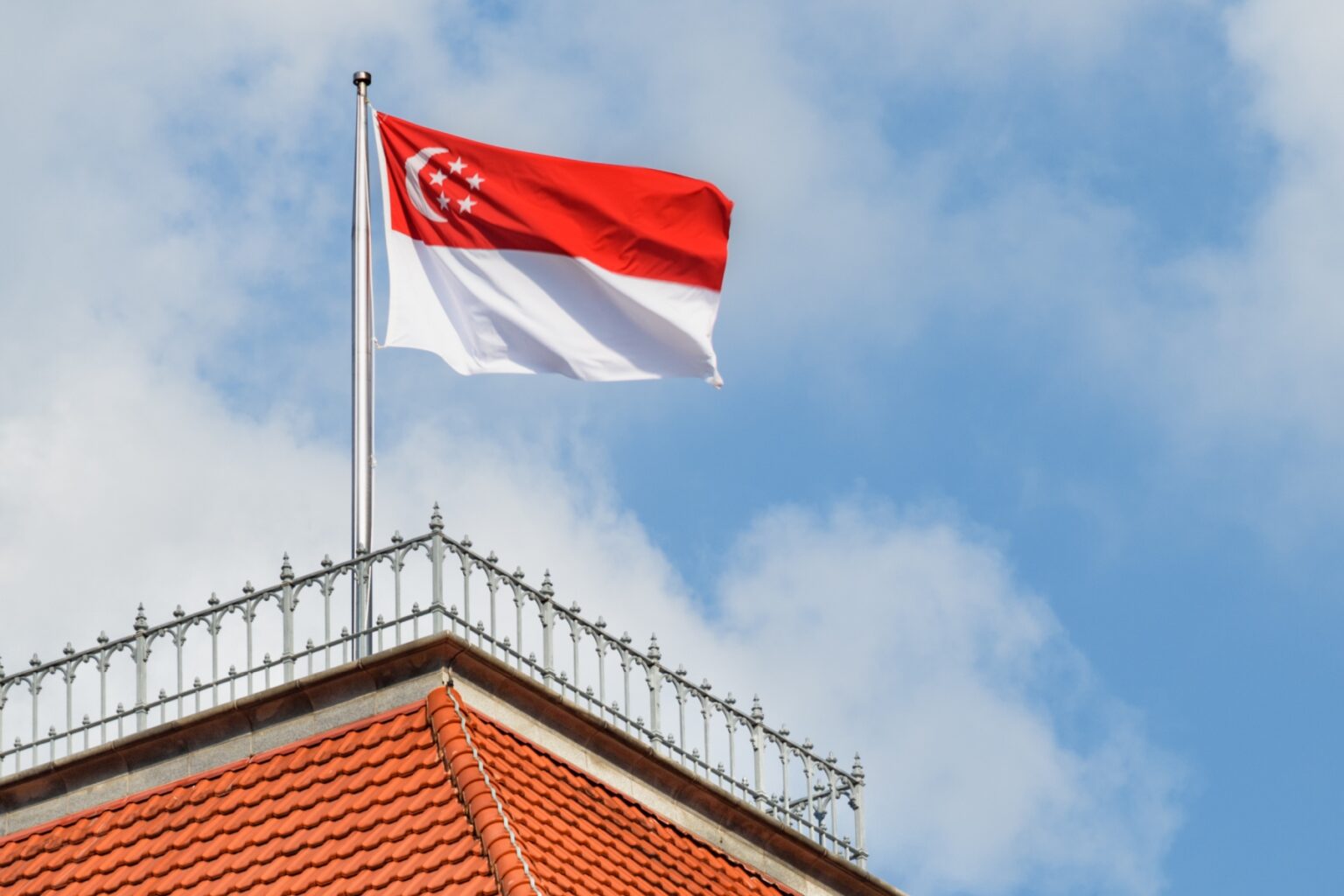 A Singapore flag in top of a building