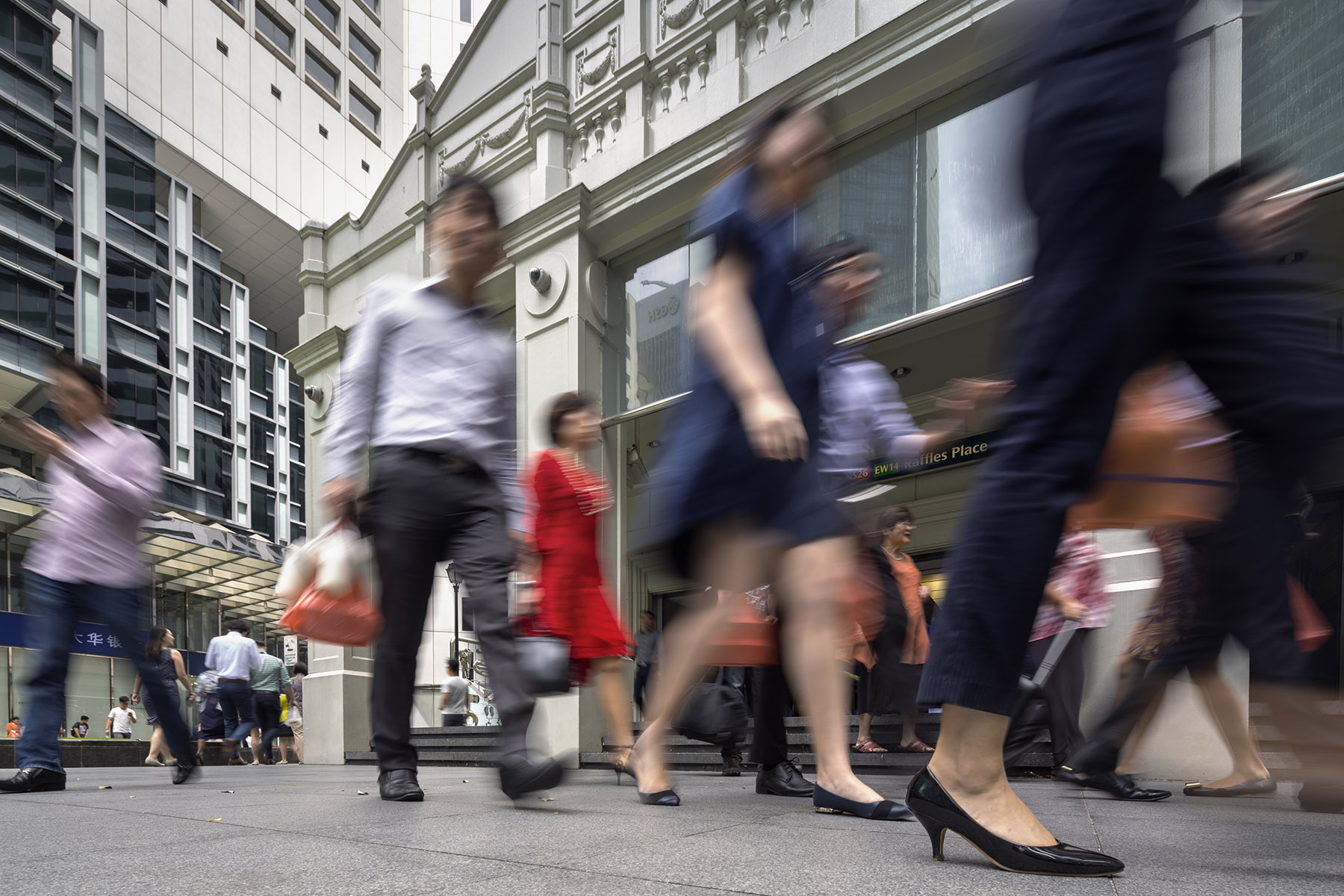 Office workers in Singapore's financial district - motion blur