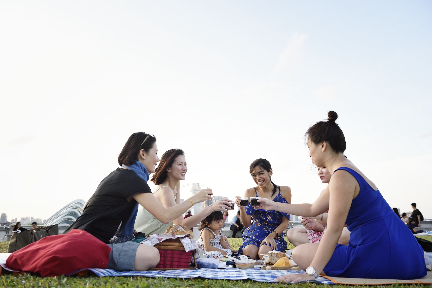 A group of friends meets for a picnic in the park on a summer day