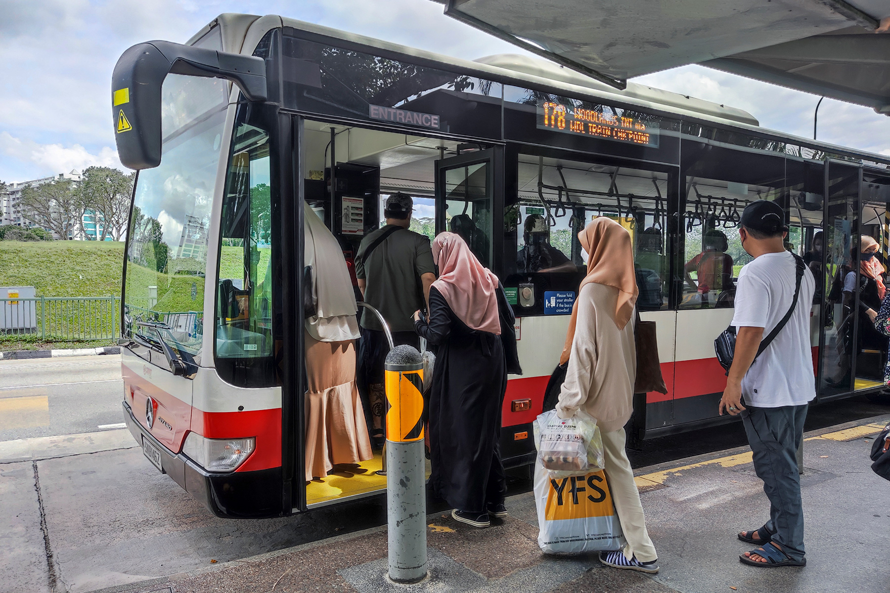 People getting onto a bus in Singapore