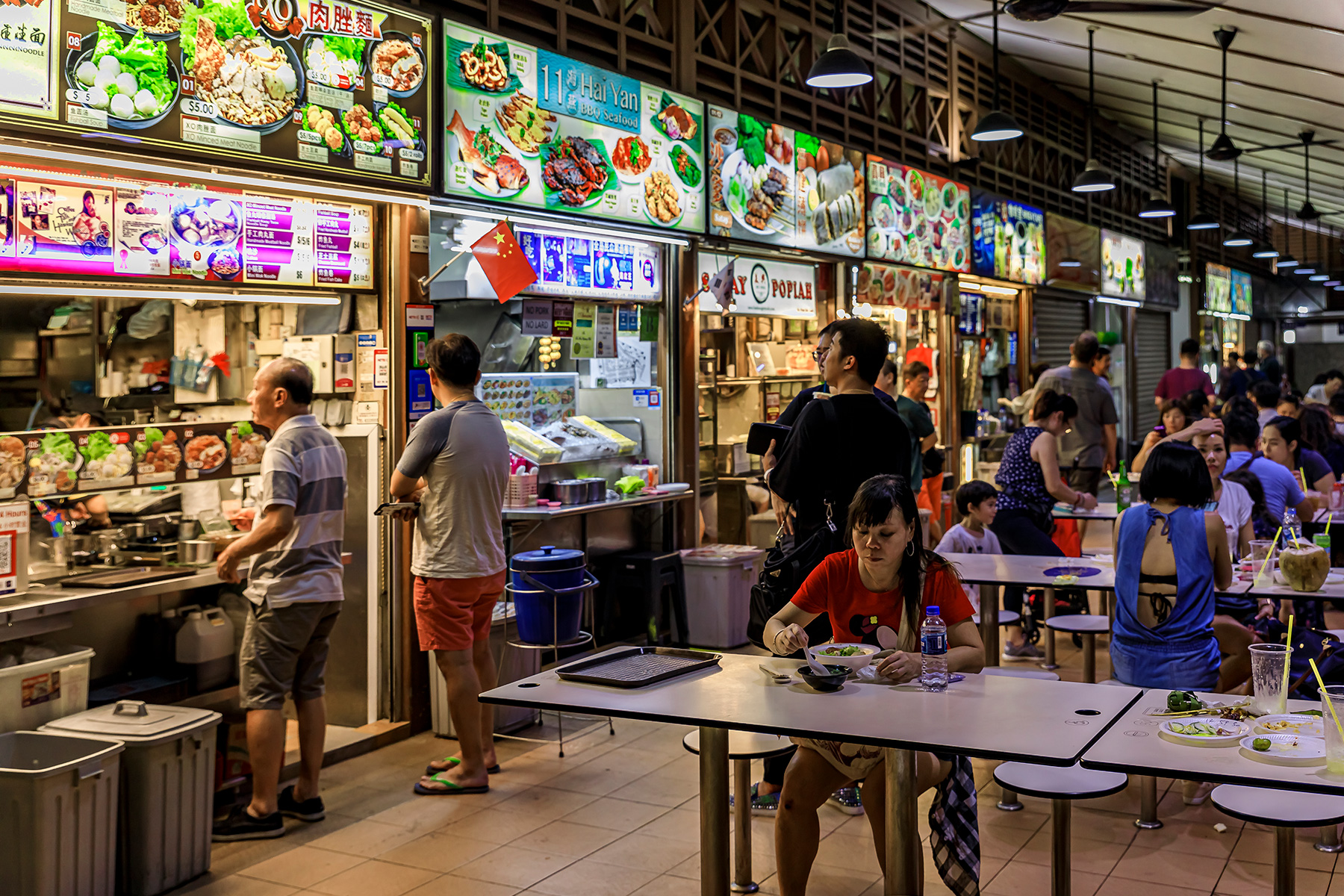 People eating and ordering at a hawker center in Lau Pa Sat Telok Ayer Market