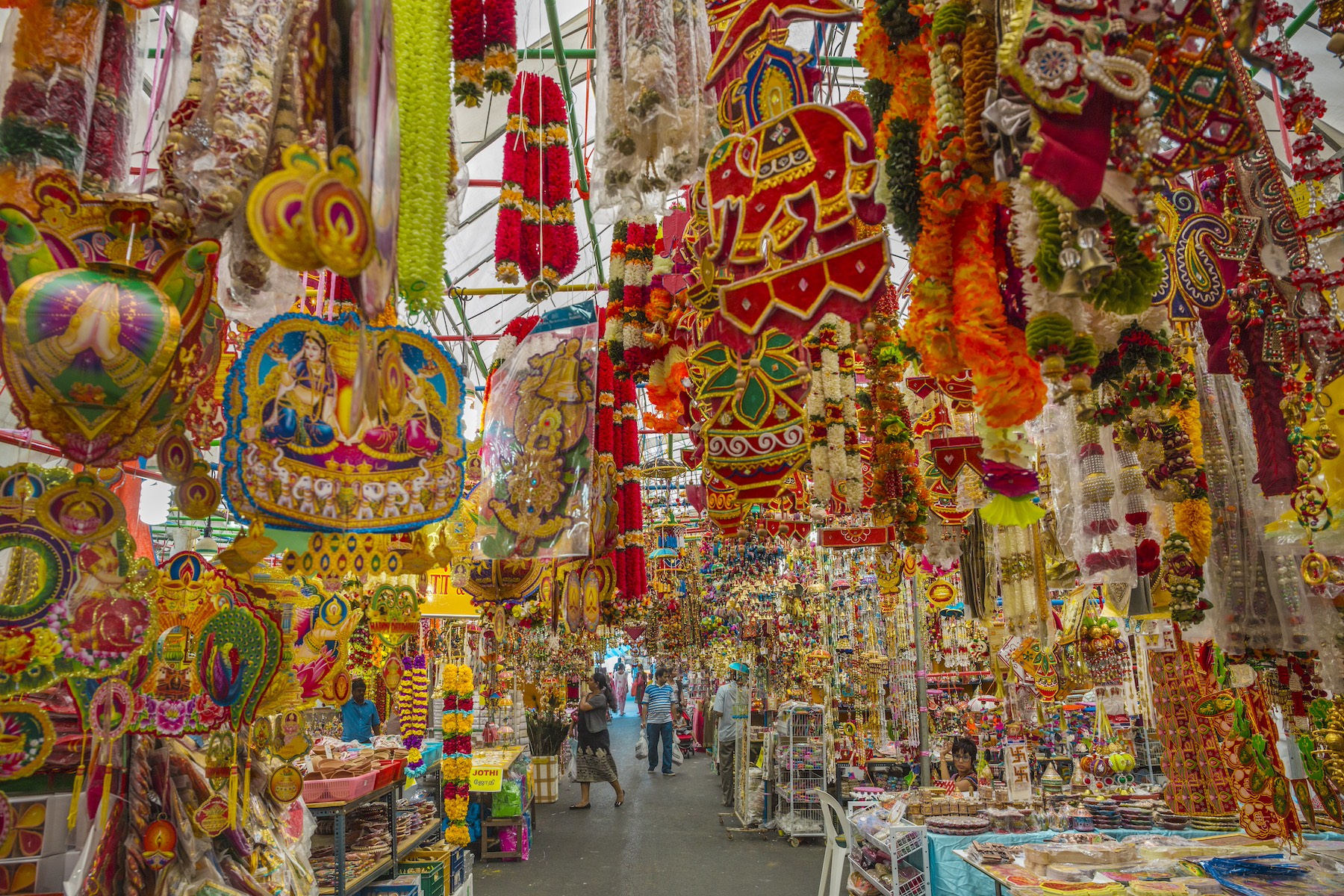Colorful traditional paper crafts hang from the ceiling at a market in Little India, Singapore