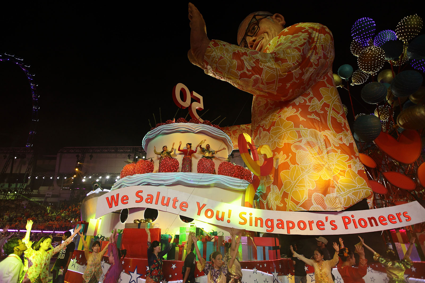 Dancers, performers, floats, and a huge audience celebrate Singapore's 50th anniversary of independence.