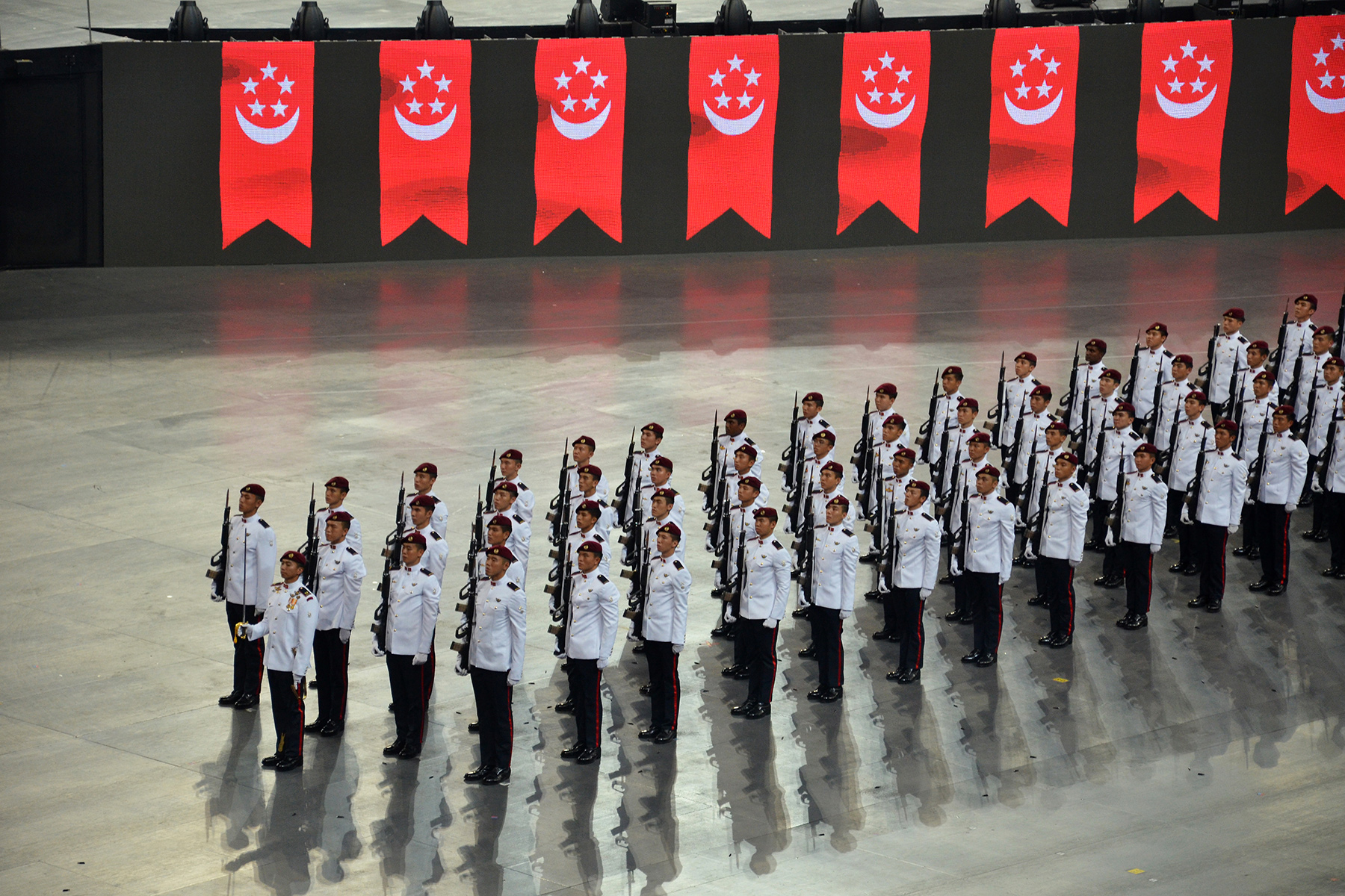 Military parade rehearsal in front of Singapore flags