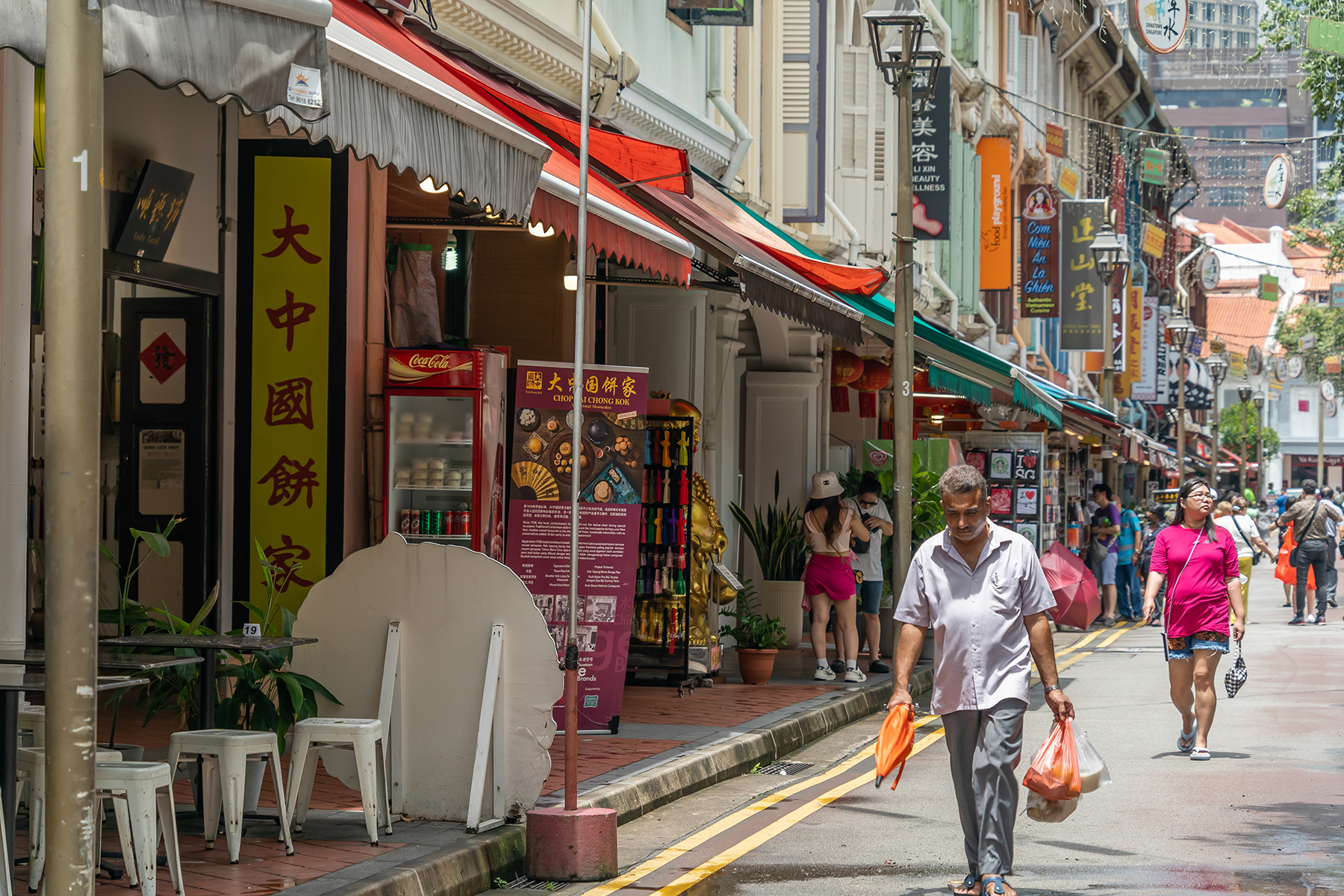 A man walking down the street in Singapore's Chinatown