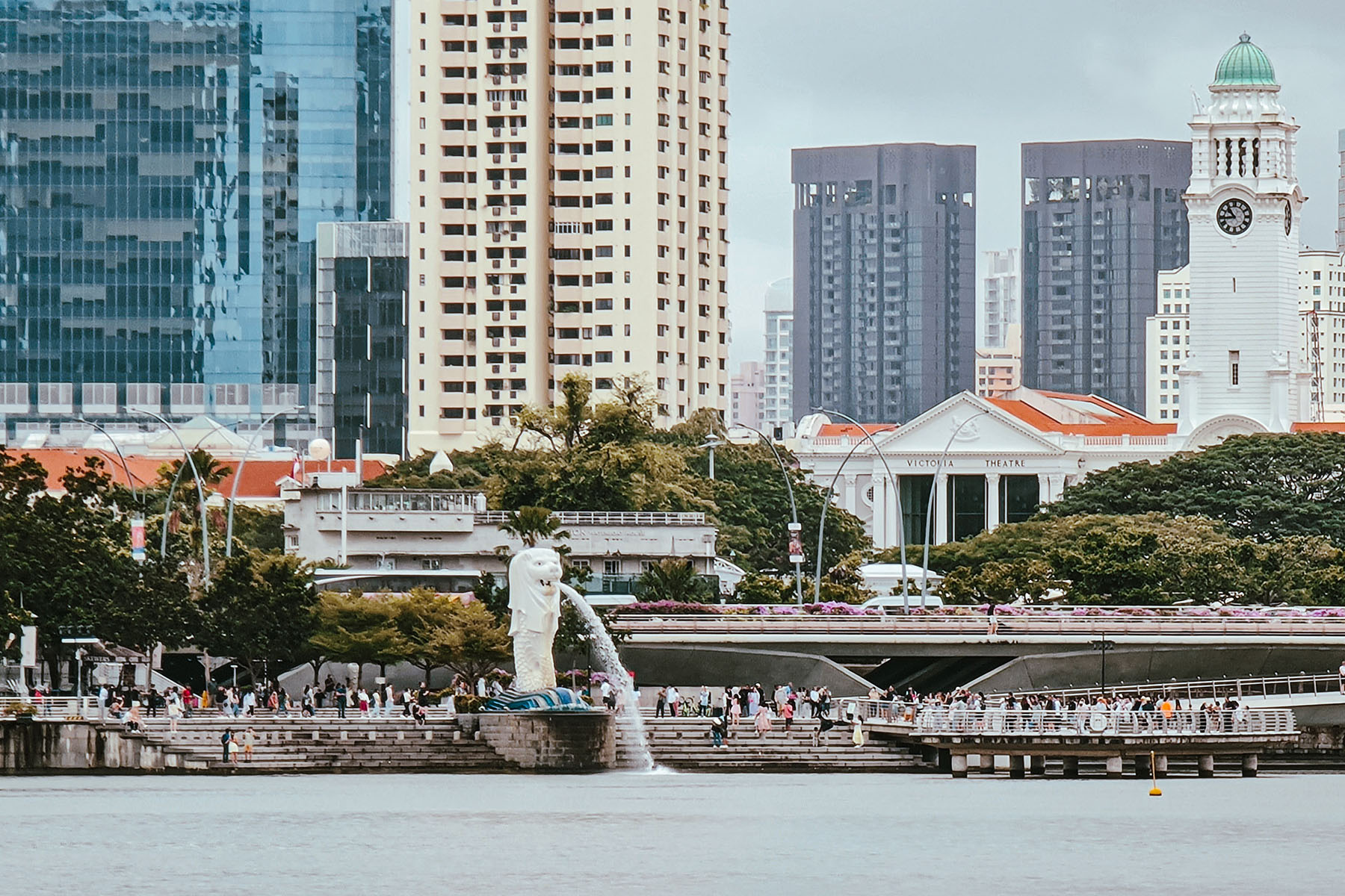 People walking near Marina Bay with its famous Merlion.