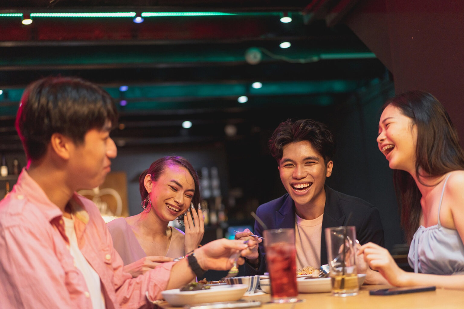 Group of friends laughing in a bar