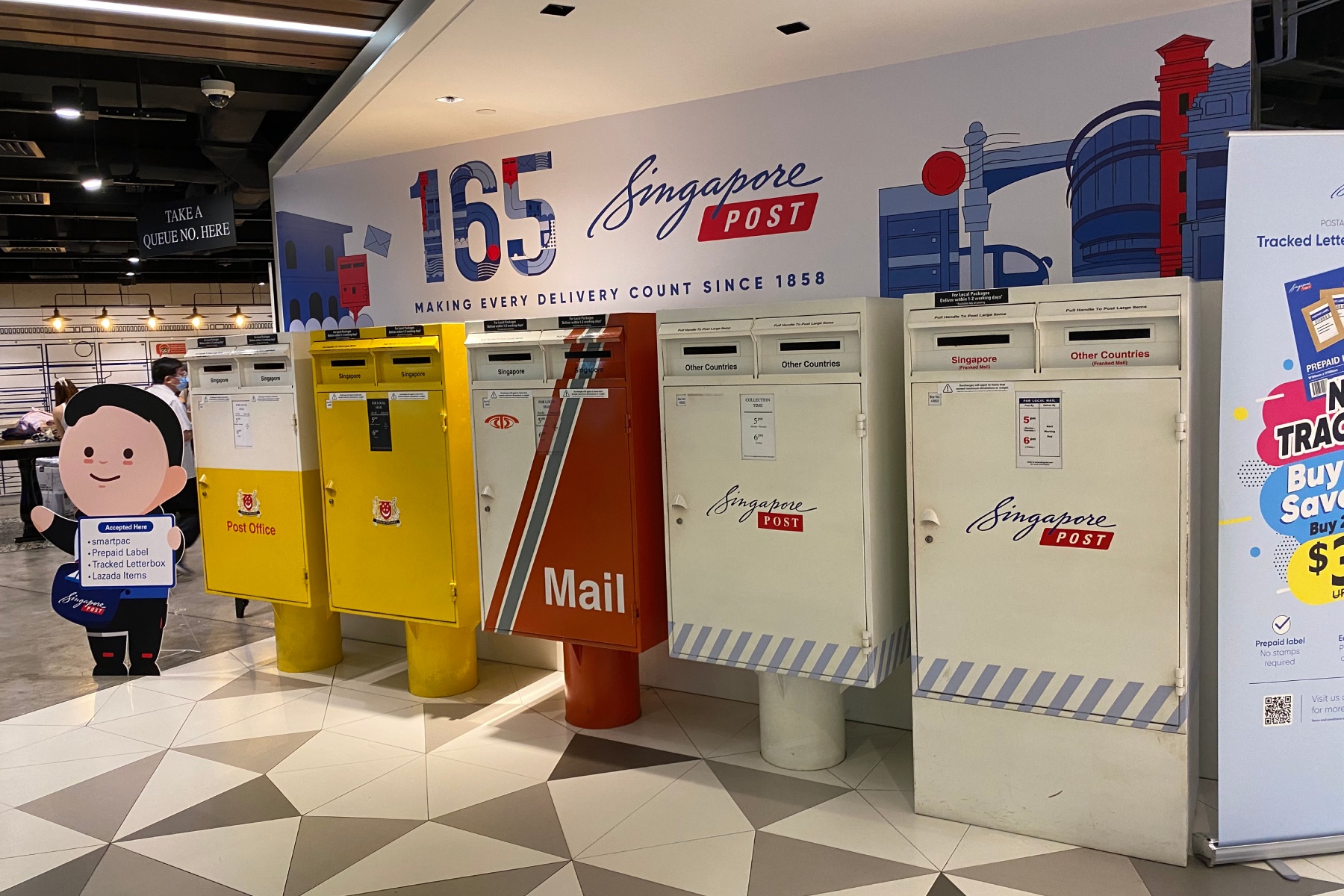 A row of five different mailboxes offering different Singapore Post services