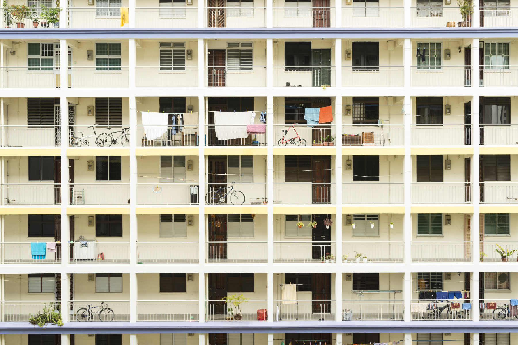 Yellow facade of a 50-year-old residential HDB flat in Singapore. It's looking very clean and neat.