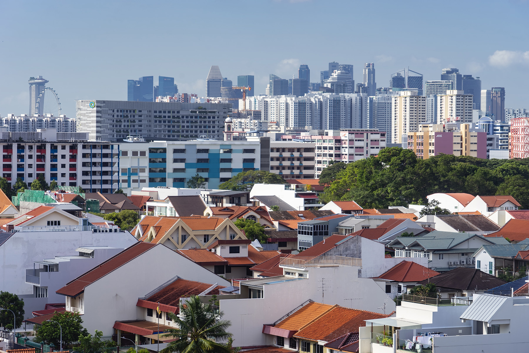 Houses, HDB apartment blocks, and office buildings loom large on the Singapore skyline.