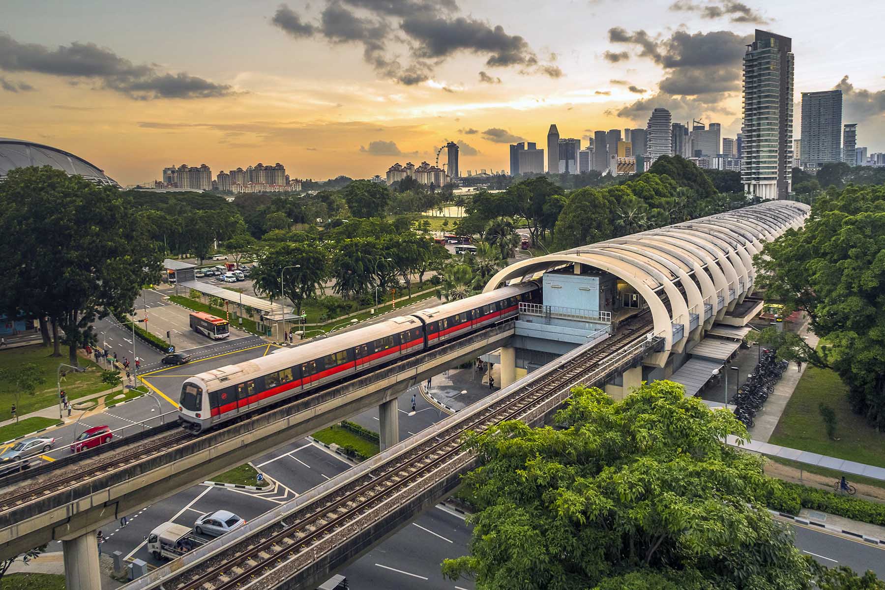 A view of Singapore mass rapid transit (MRT) train service in central Kallang station during sunset with Singapore city skyline in background. 