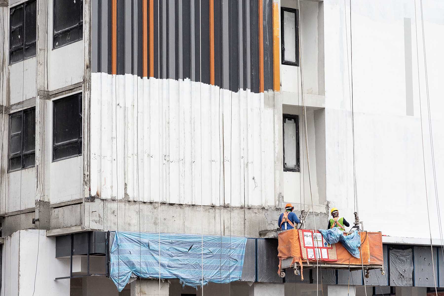 Two migrant workers at an construction site in Singapore.