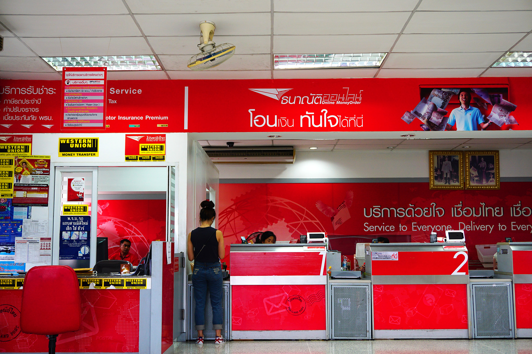 A western Union kiosk next to a Thai post office branch