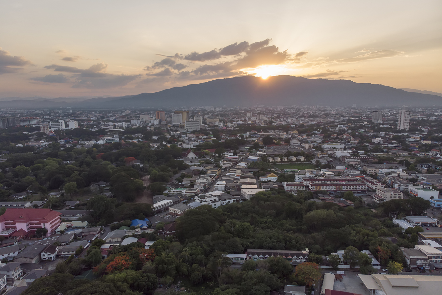 Aerial view of Chiang Mai at sunset or sunrise across the mountains