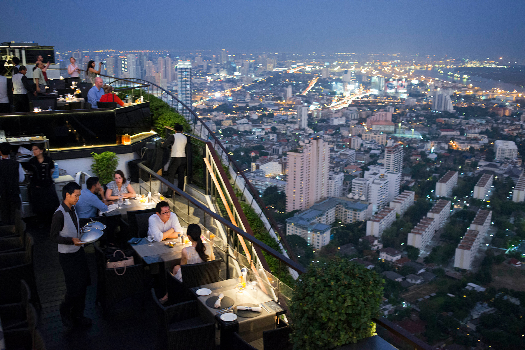 People eating at a rooftop restaurant in Bangkok