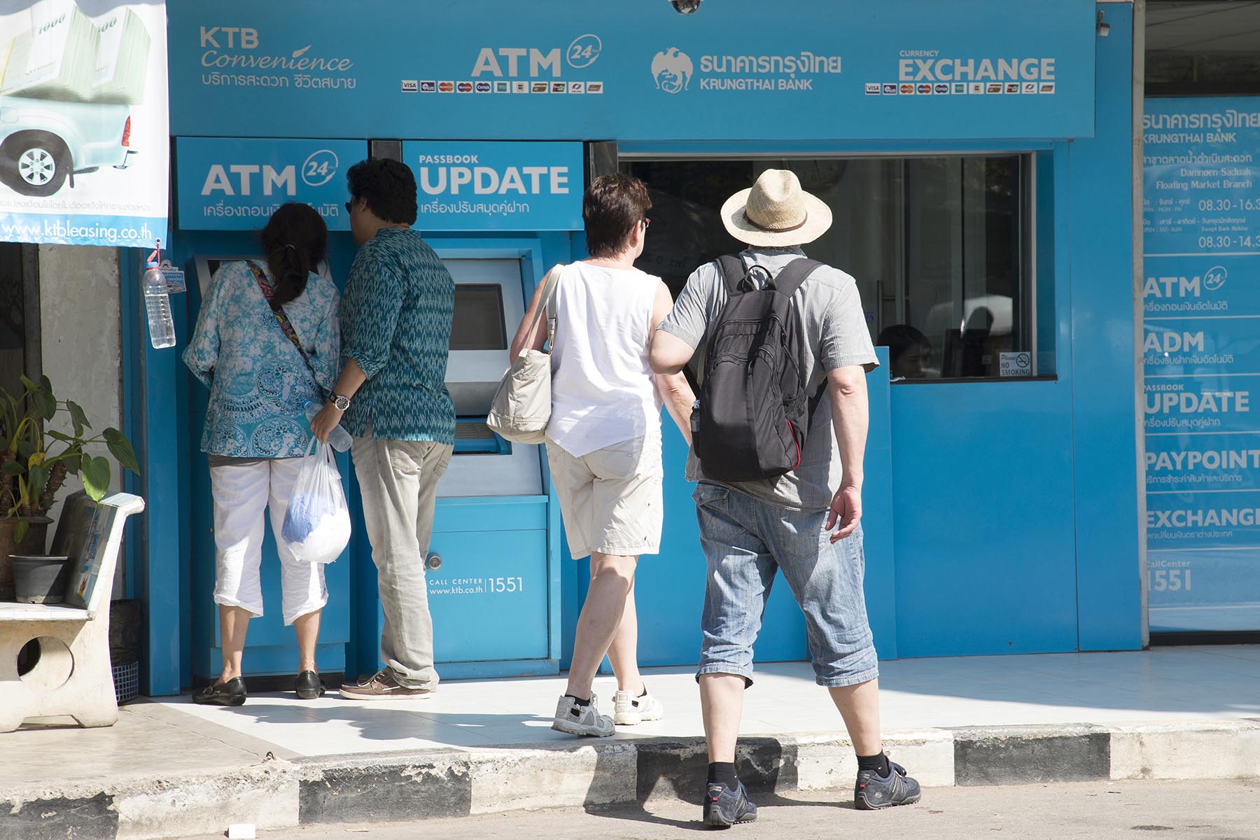 Tourists using the ATM at a Krungthai Bank in Damnoen Saduak, Thailand.
