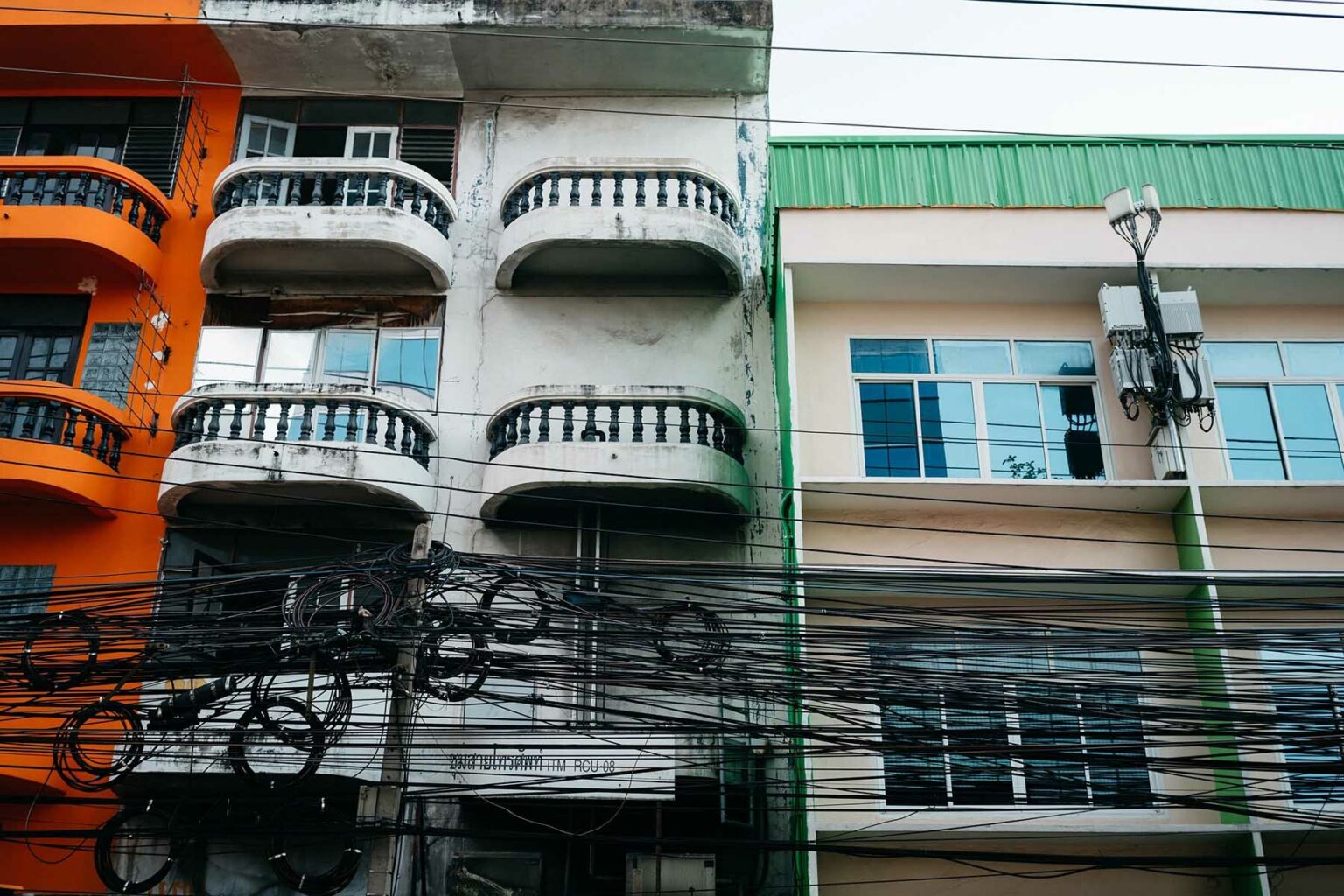 Thai houses with power lines outside.