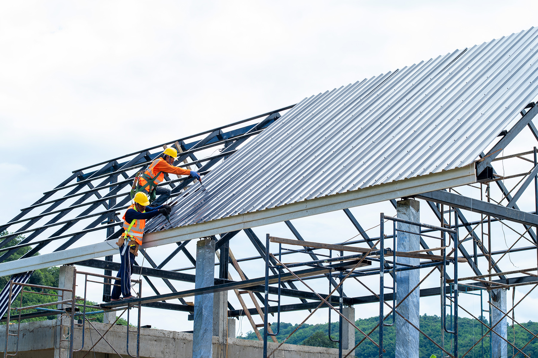 Construction workers building a roof