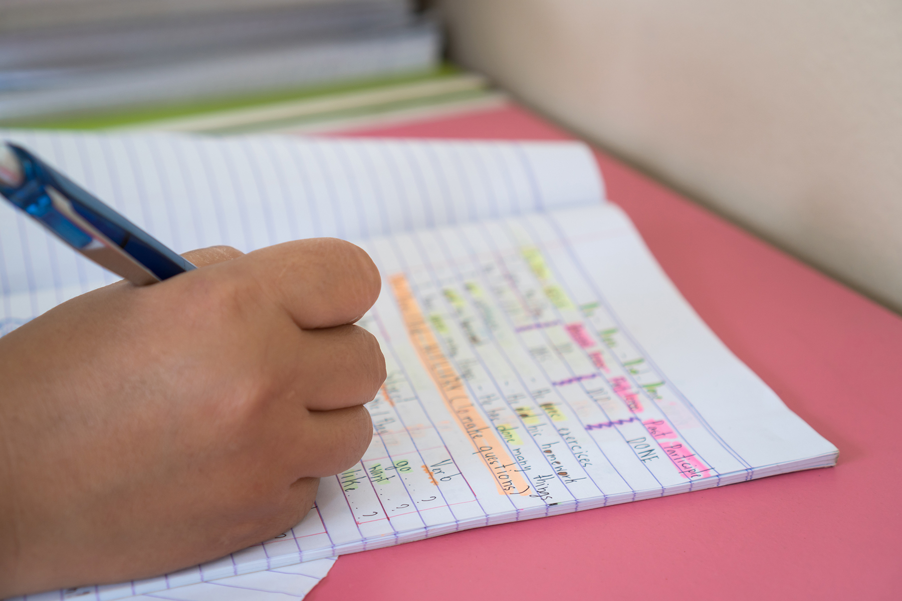 Close-up of a hand writing English homework