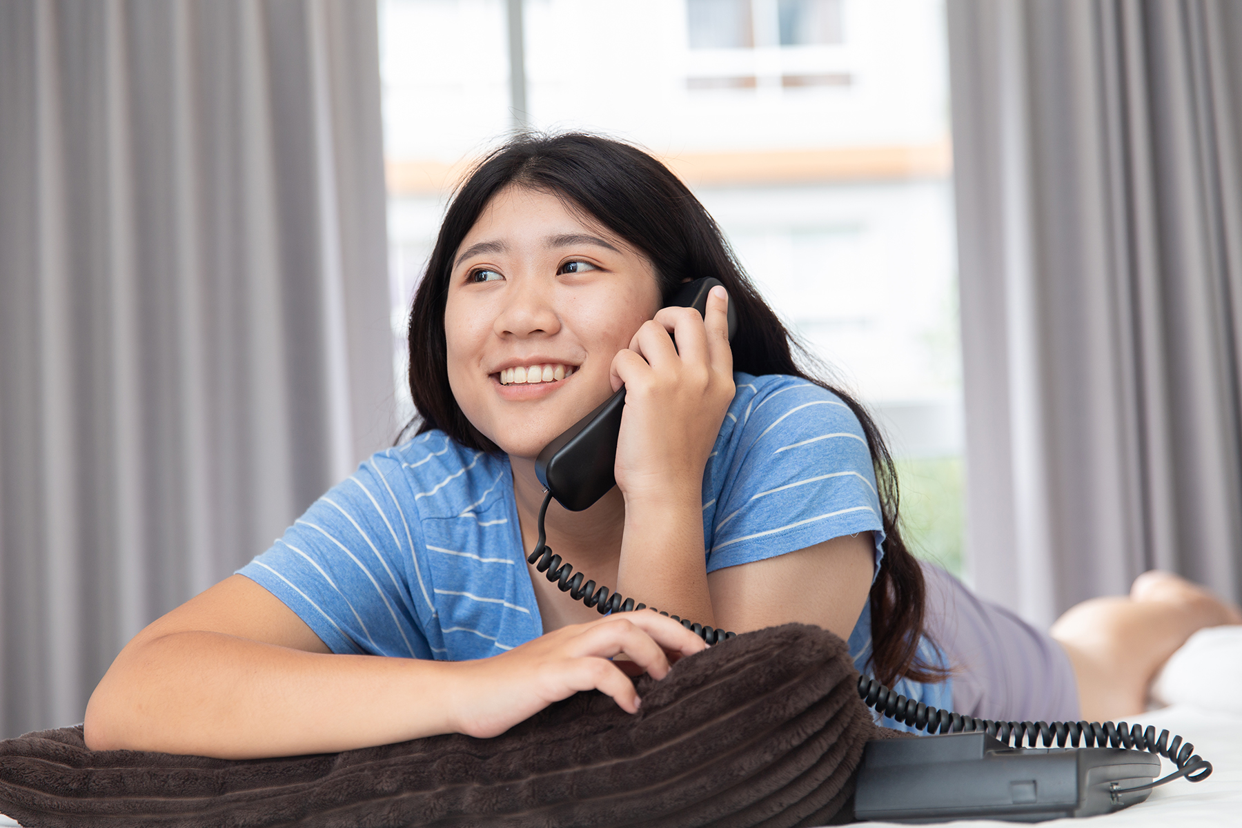 Smiling woman on a landline phone