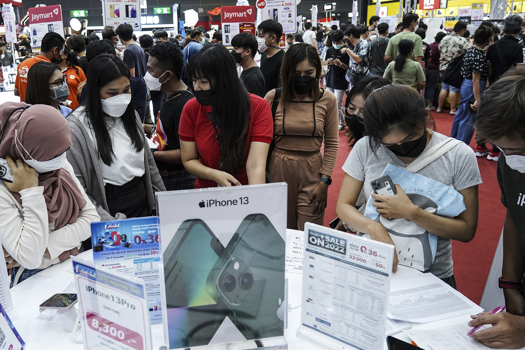 A visitor inspects iPhone mobile phones at the Thailand Mobile Expo in Bangkok, Thailand, 14 May 2022.