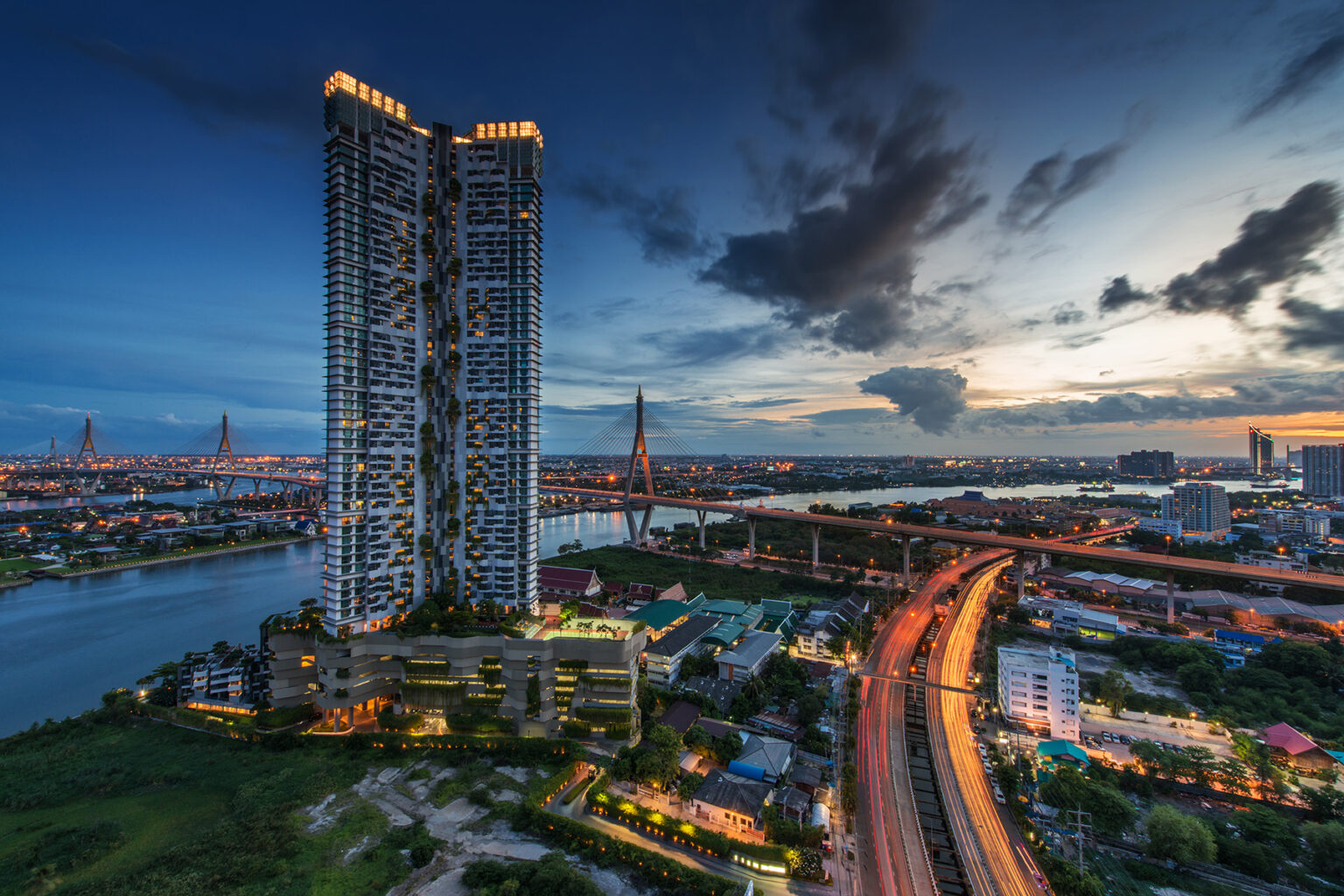 Bangkok skyline early evening, two tall high rise condominium on the left side overlooking the Bhumiphol Industrial Bridge