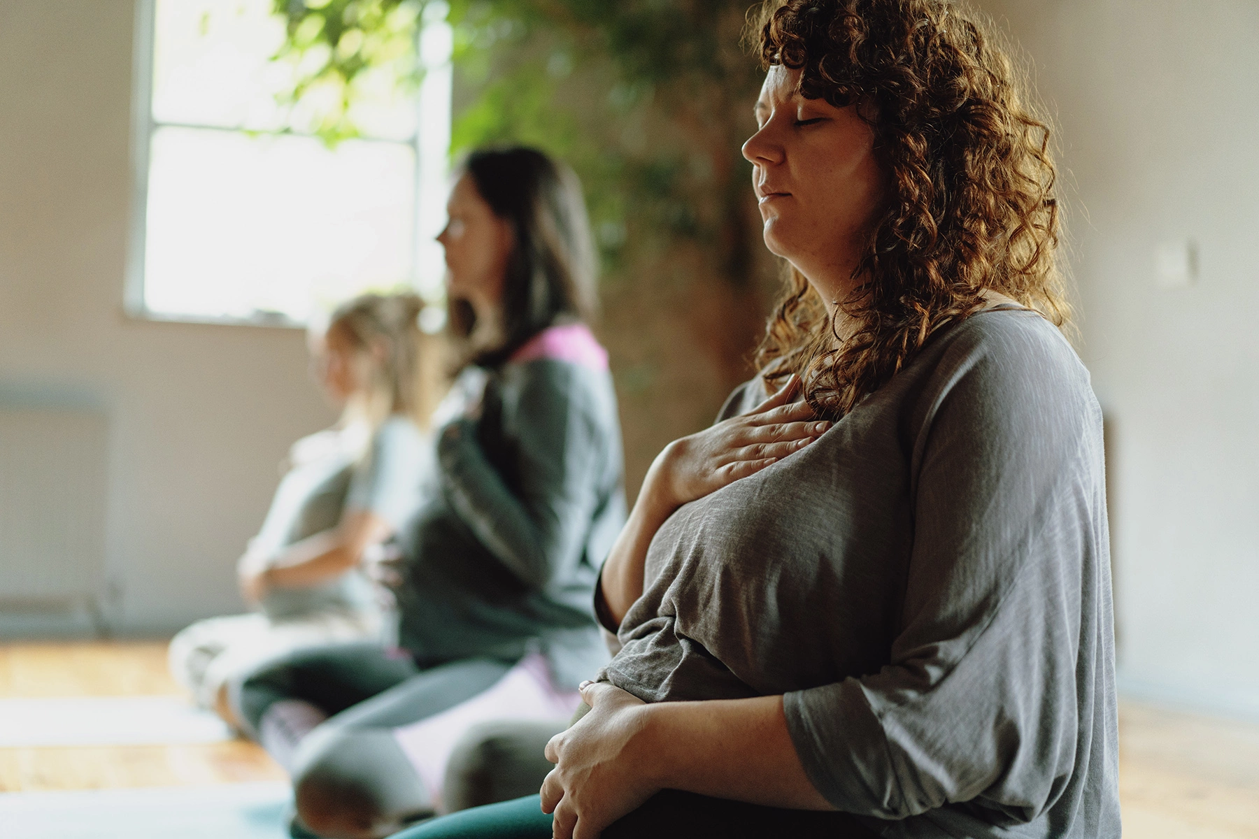 A pregnancy yoga class, the mums are working on their breathing

