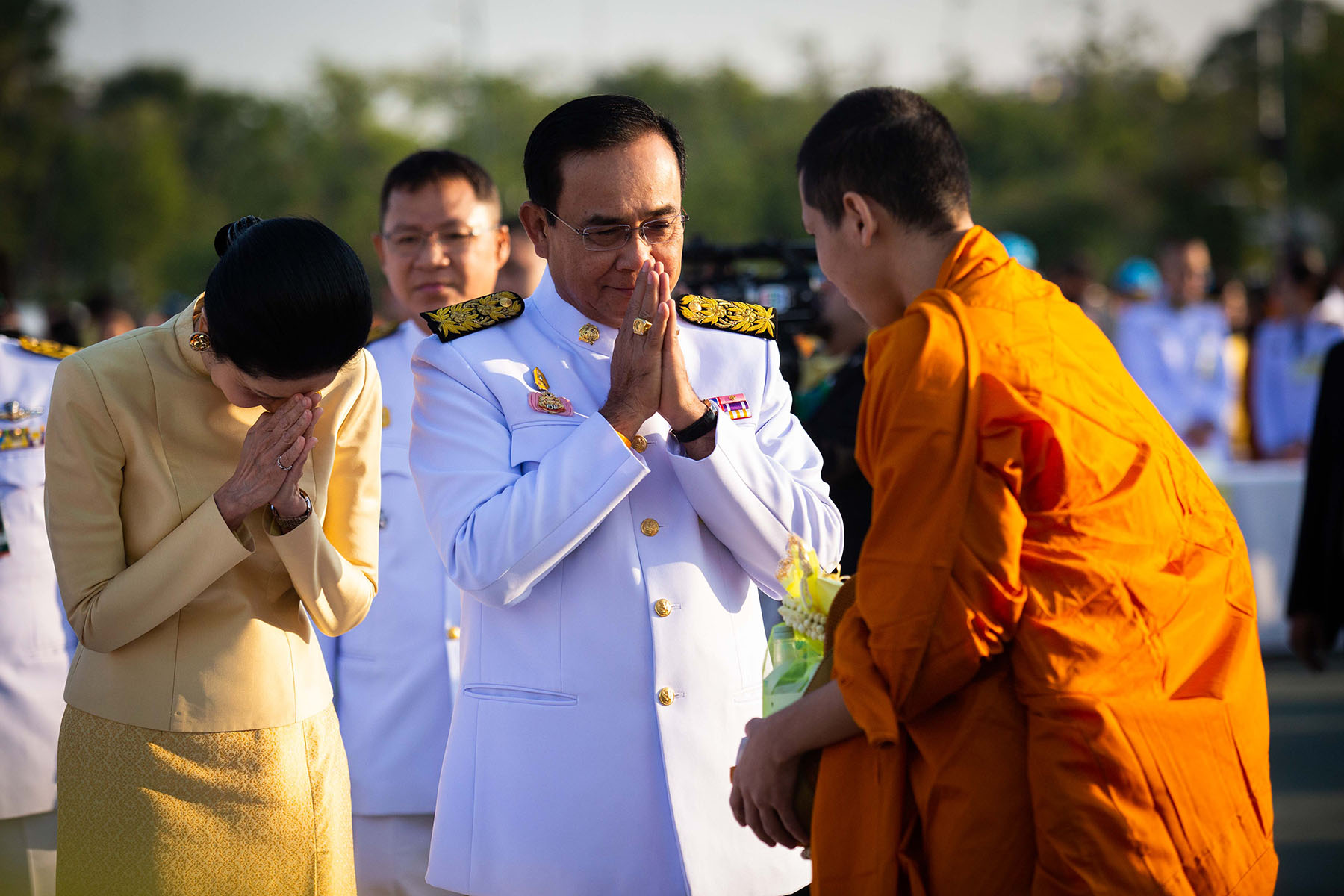 Former Prime Minister, General Prayut Chan-O-Cha waiing a monk during a commemorative ceremony for the late King Bhumibol's birthday at Sanam Luang, Thailand.