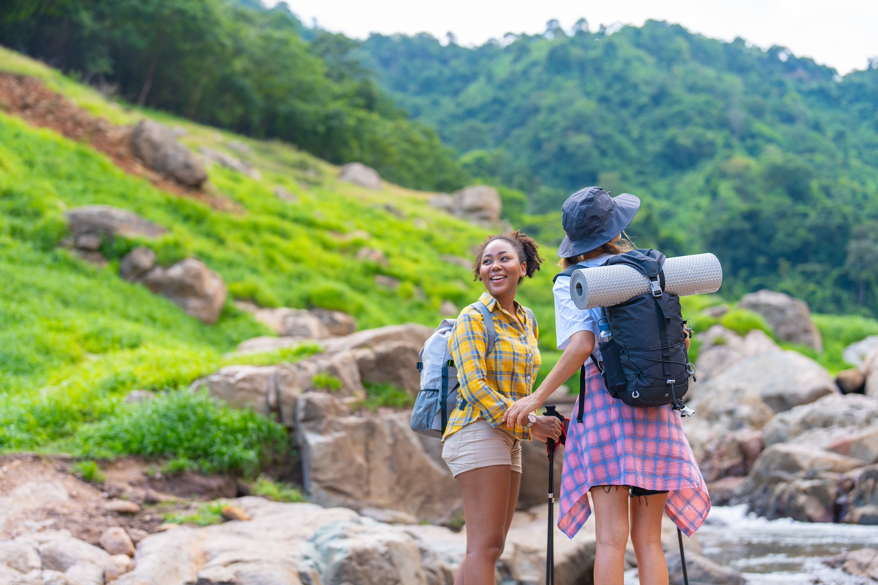 Two women are on a hiking date in a beautiful rural part of Thailand