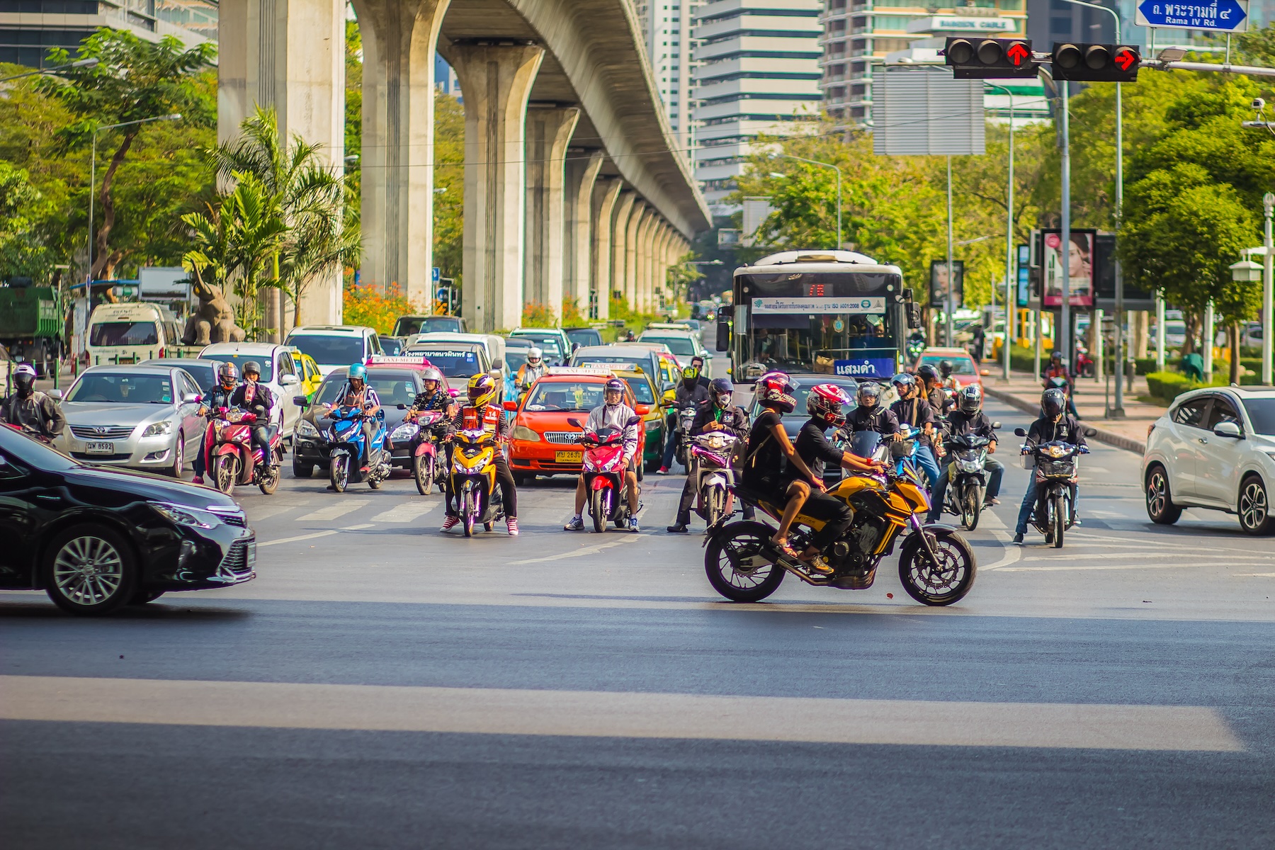 A heavy traffic jam with cars, buses, and bikes at Thai-Japanese bridge junction in Bangkok, Thailand