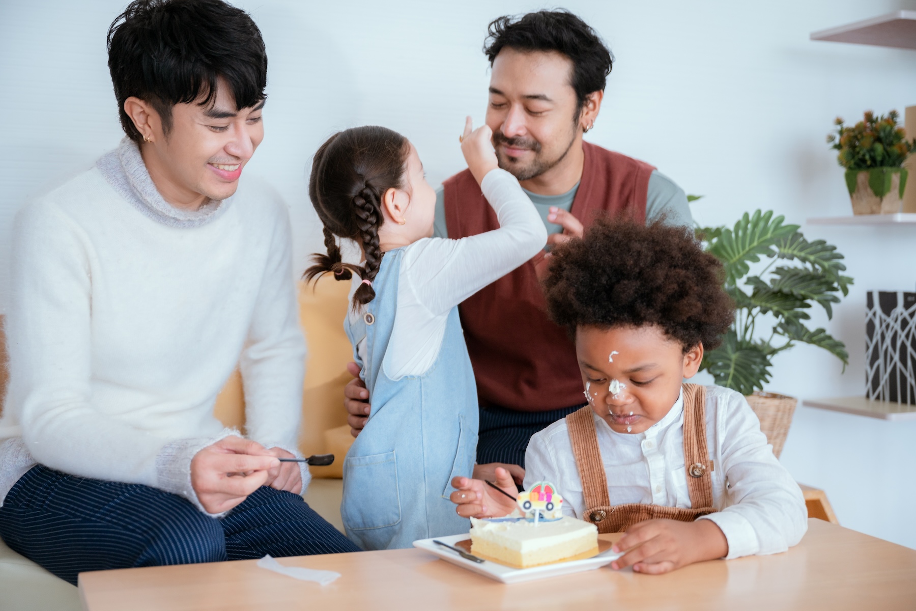 A family celebrates one of the children's birthdays with cake